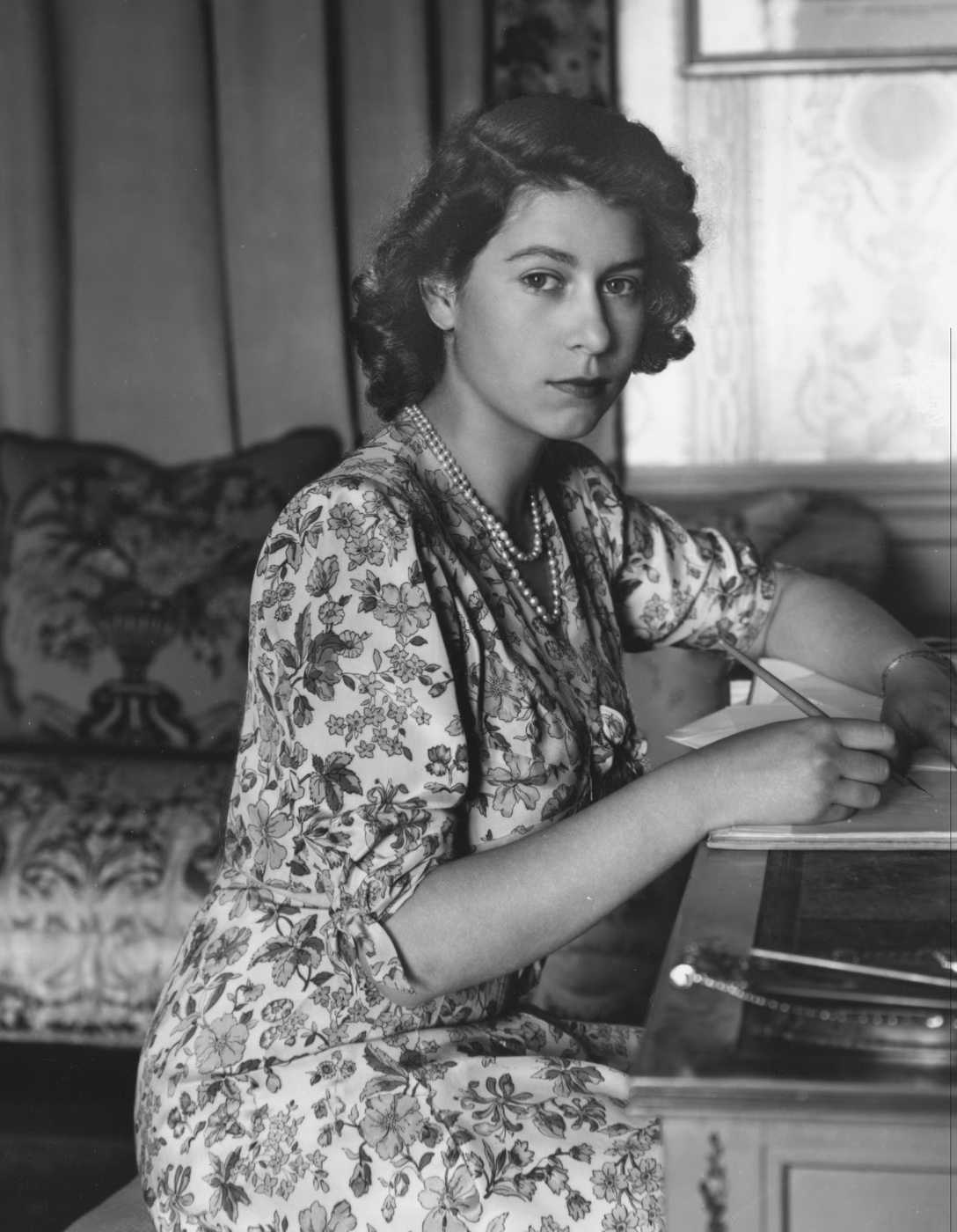 Princess Elizabeth writing at a desk, 1940s