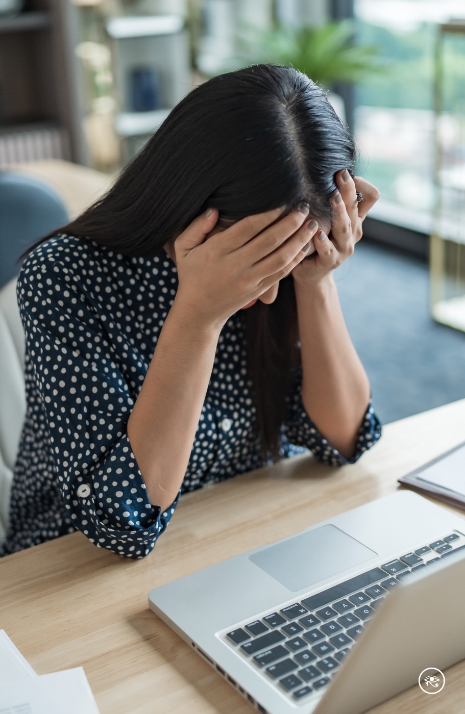 Woman overwhelmed at her desk